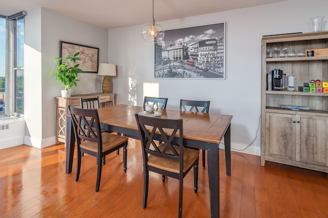 dining space with hardwood / wood-style flooring