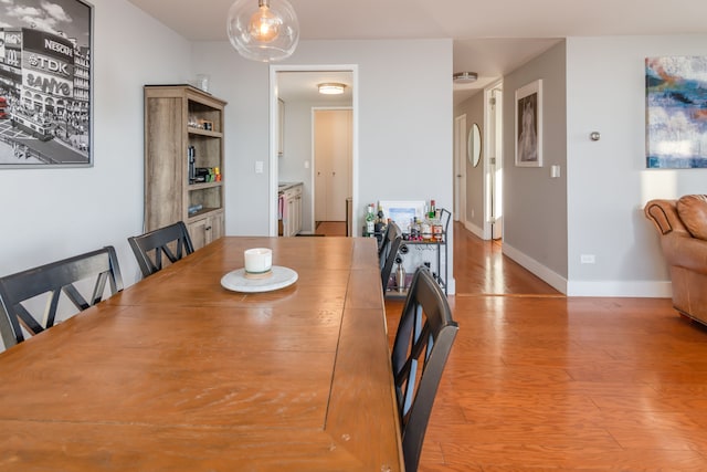 dining space with light hardwood / wood-style flooring