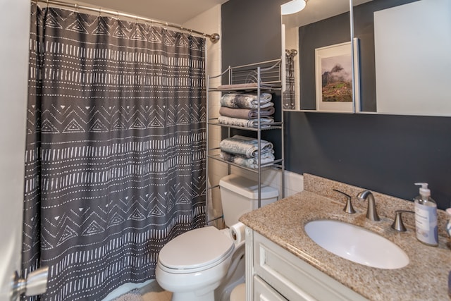 bathroom featuring vanity, toilet, and walk in shower