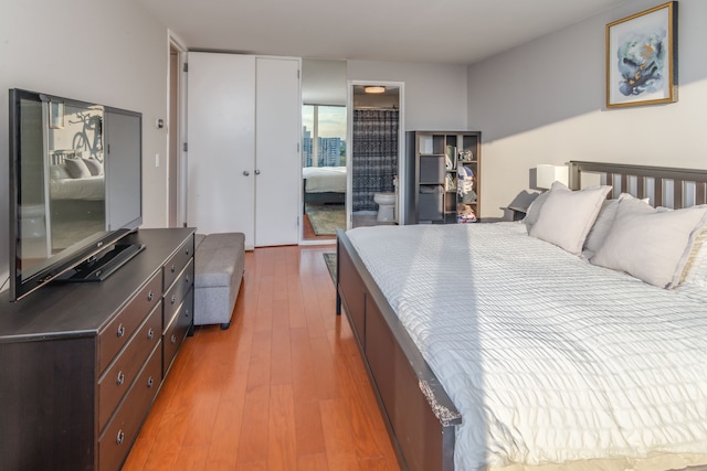 bedroom featuring light hardwood / wood-style floors and connected bathroom