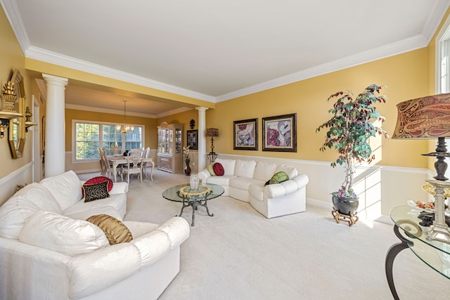 living room featuring carpet flooring, ornate columns, and crown molding