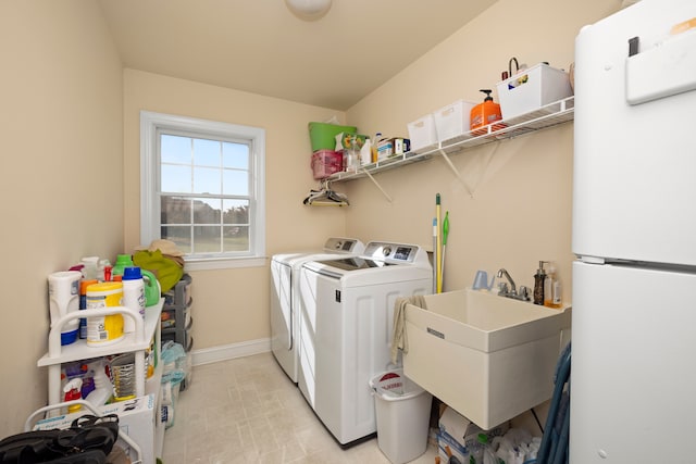 laundry room featuring washer and dryer and sink