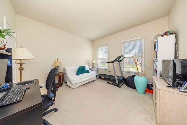 home office with light carpet and vaulted ceiling