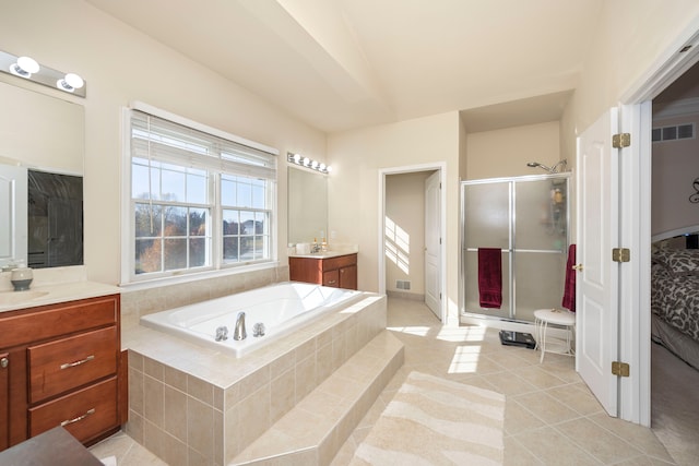 bathroom with plus walk in shower, tile patterned flooring, and vanity