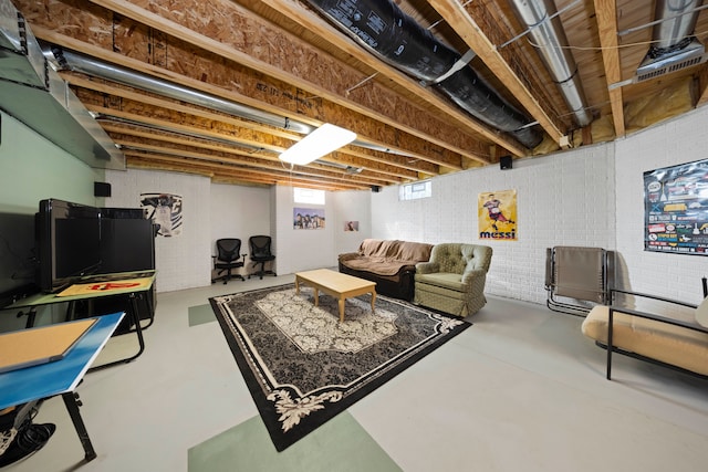 living room with concrete floors and brick wall