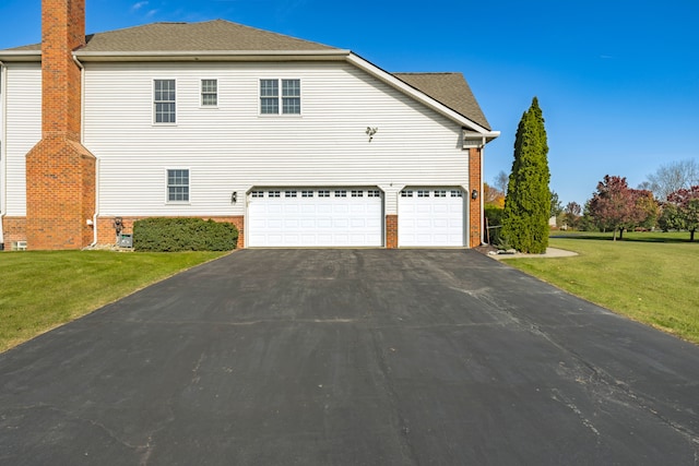 view of home's exterior featuring a garage and a lawn