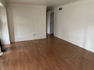 empty room featuring dark wood-type flooring