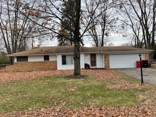 single story home with a garage and a front yard