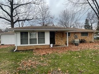 back of house featuring a yard