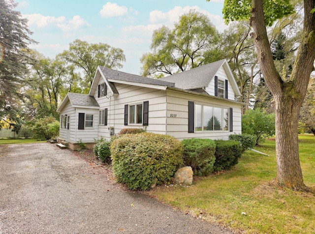 view of property exterior featuring a lawn