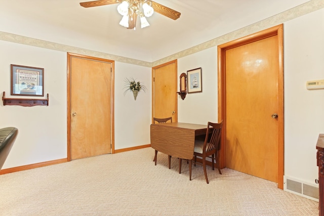 carpeted dining space featuring ceiling fan