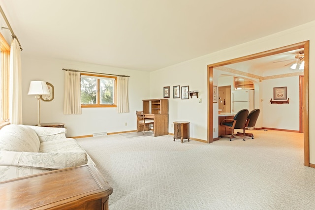 carpeted living room featuring ceiling fan