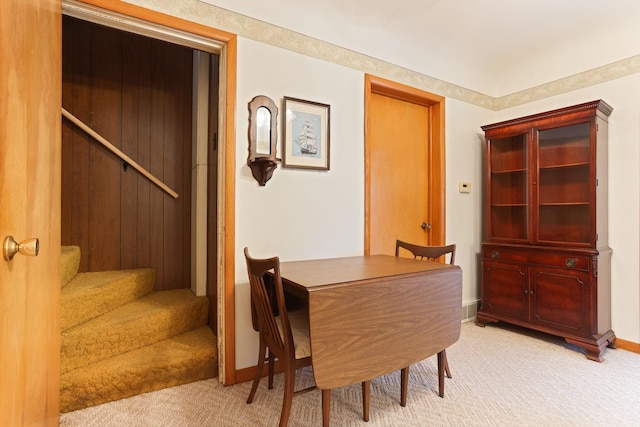 dining room featuring light carpet