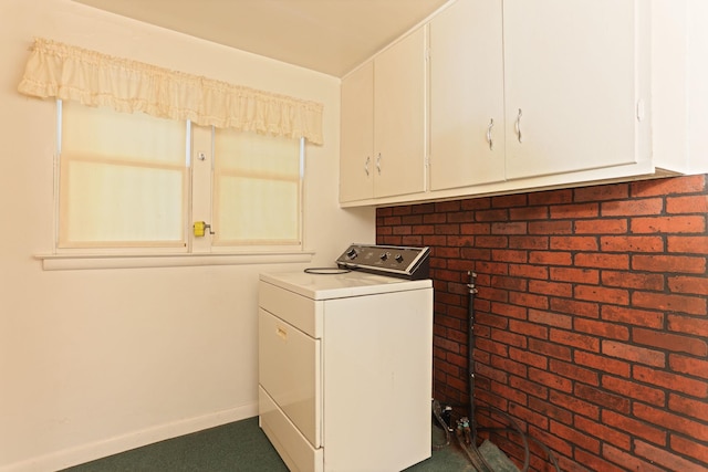 washroom with cabinets, washer / dryer, and dark colored carpet