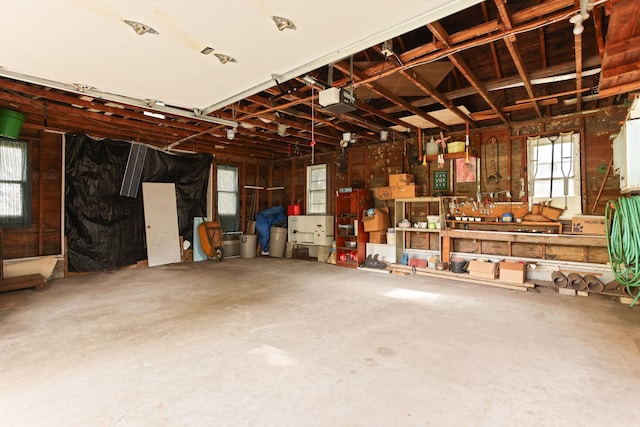 garage with a workshop area and a garage door opener