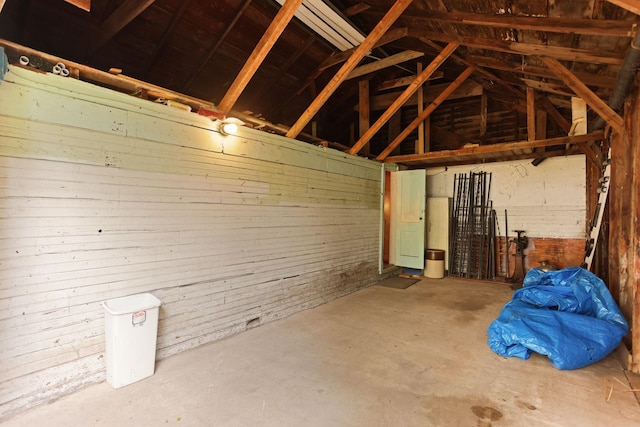 miscellaneous room featuring concrete floors and vaulted ceiling