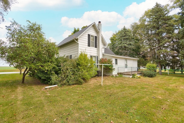 view of side of property with a yard