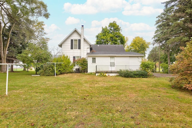 back of property with a lawn