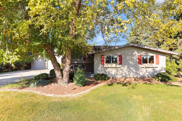 view of front of property with a garage and a front lawn