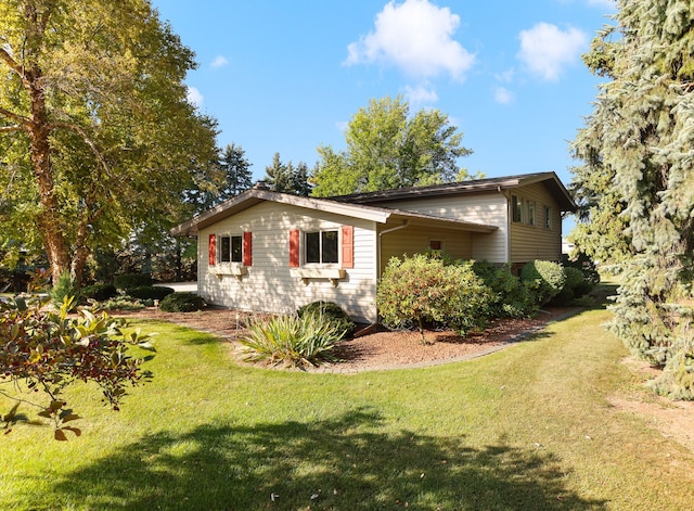 view of side of home featuring a lawn