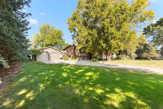 view of front of property featuring a garage and a front lawn