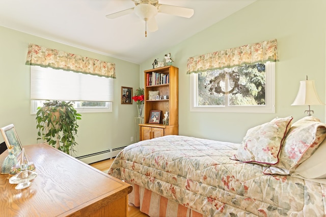 bedroom with ceiling fan, light hardwood / wood-style floors, baseboard heating, and vaulted ceiling