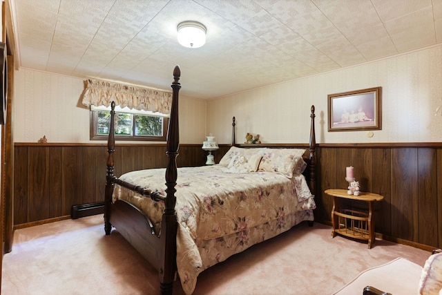 carpeted bedroom with wooden walls and a baseboard radiator