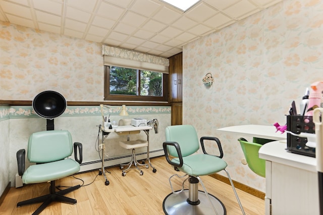 sitting room featuring a baseboard radiator and light hardwood / wood-style flooring