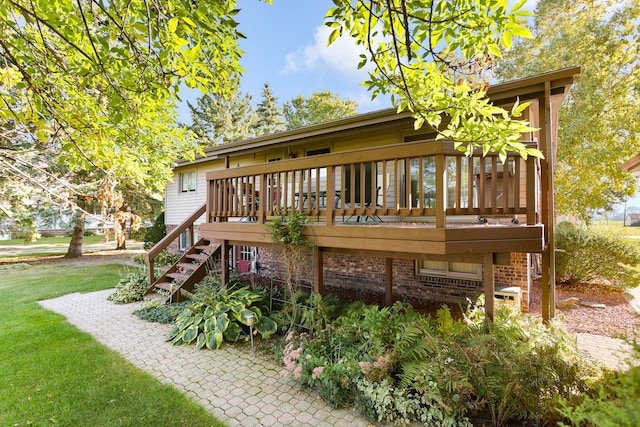 back of house with a deck and a lawn