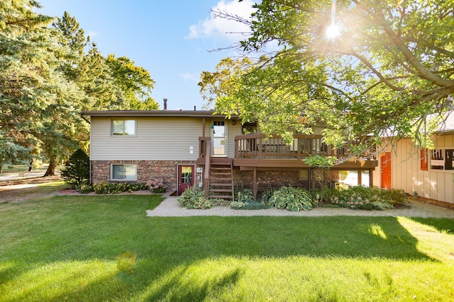 back of property featuring a deck and a yard