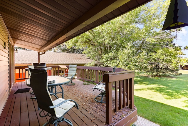 wooden terrace featuring a yard