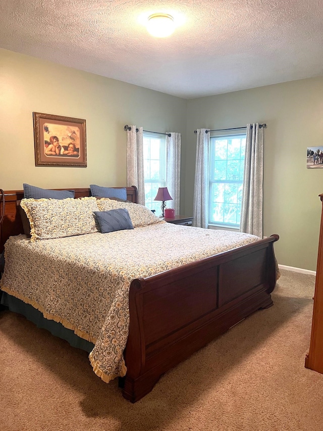 carpeted bedroom featuring a textured ceiling