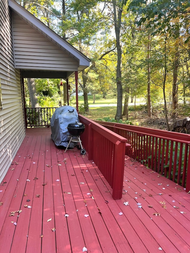 wooden terrace featuring a grill