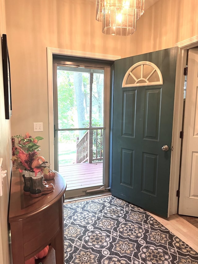 foyer entrance featuring a chandelier and hardwood / wood-style flooring