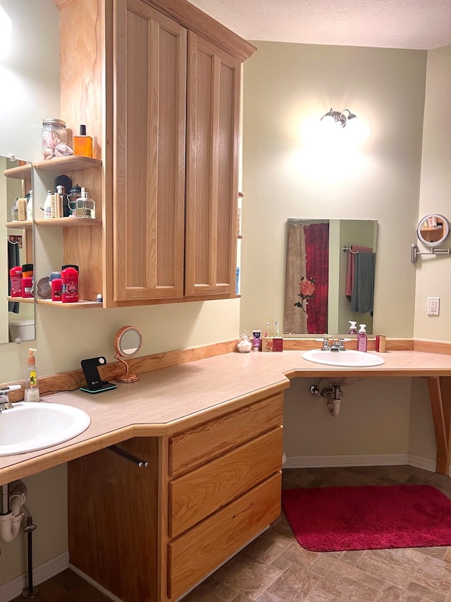 bathroom with a textured ceiling and sink