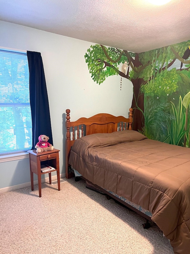 bedroom featuring carpet and a textured ceiling