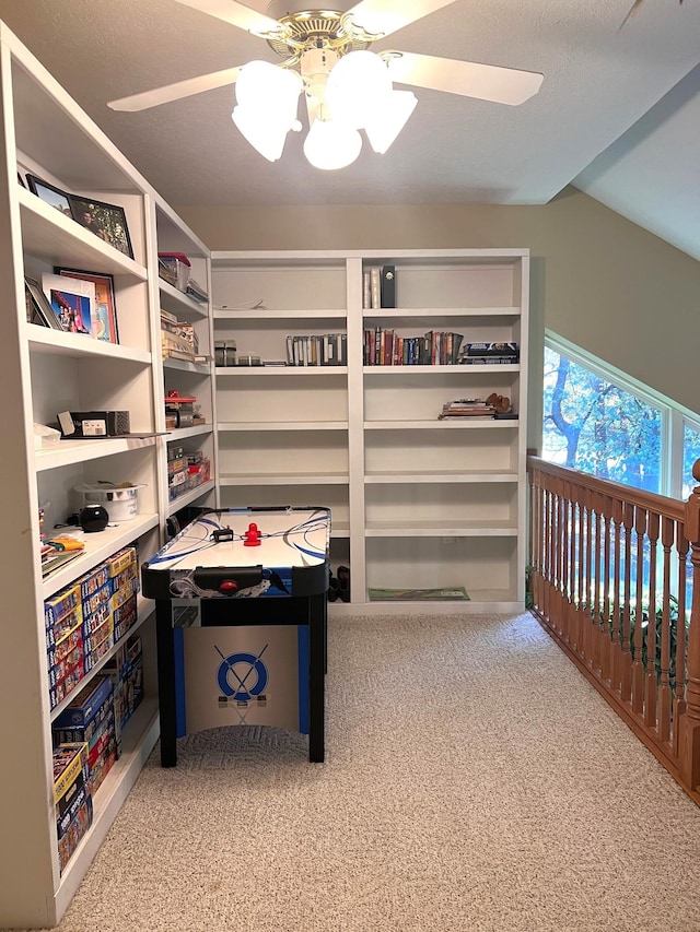 interior space with ceiling fan and light colored carpet