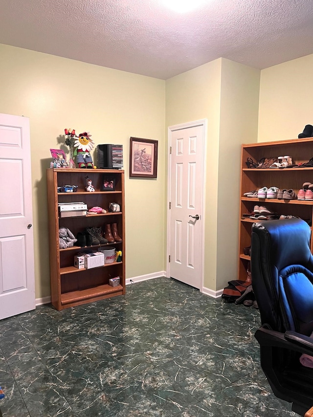 office area with a textured ceiling