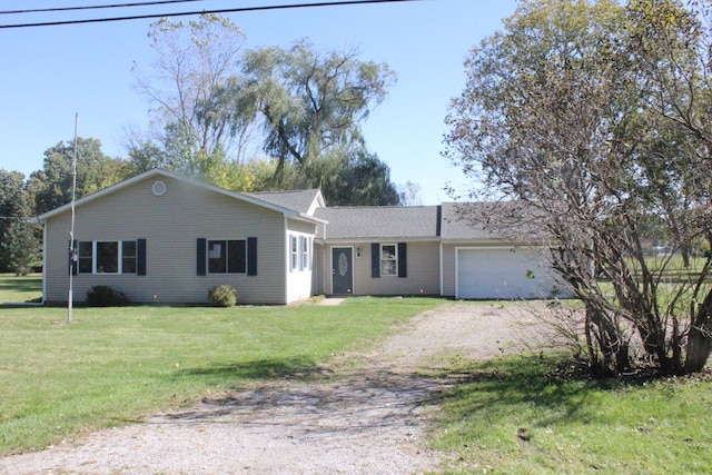 ranch-style house featuring a garage and a front lawn