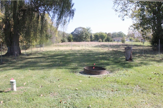 view of yard featuring a rural view and a fire pit