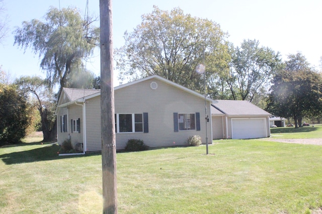 single story home with a garage and a front lawn