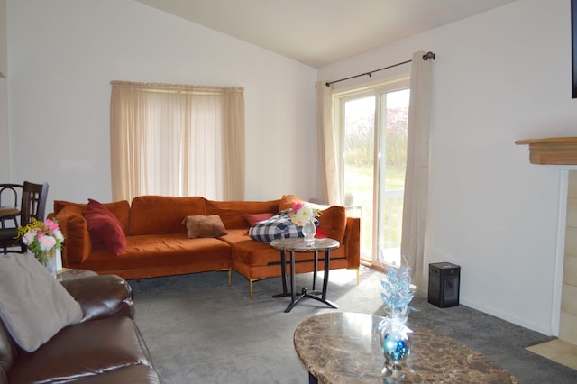 carpeted living room with vaulted ceiling