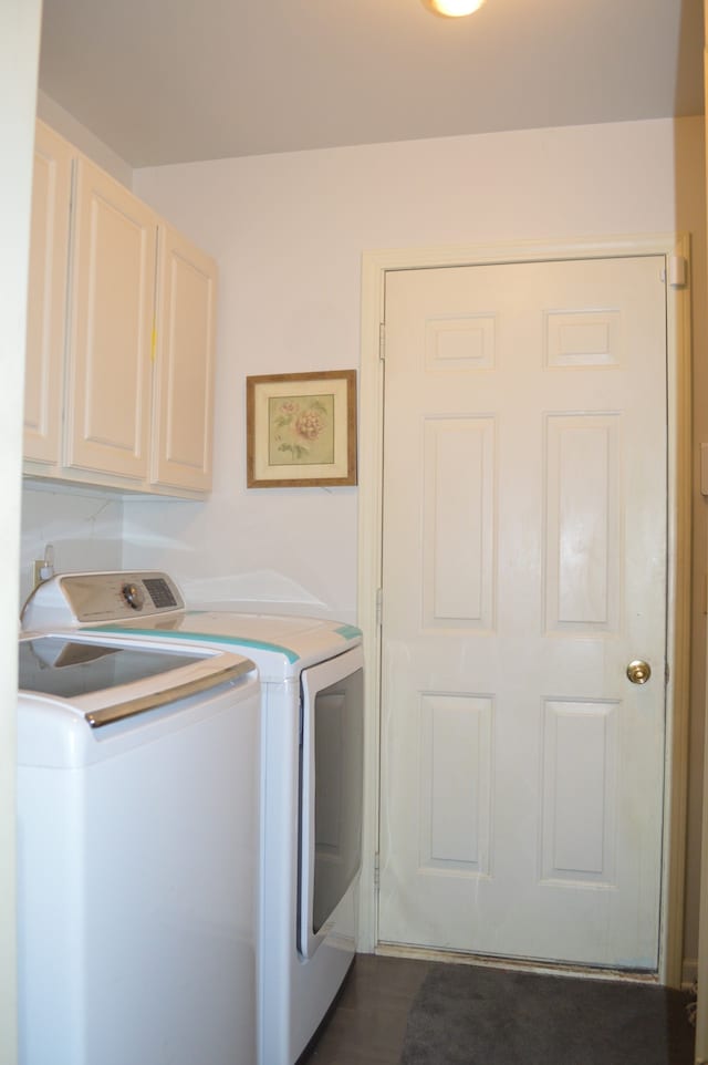 washroom with washer and clothes dryer, cabinets, and dark hardwood / wood-style floors