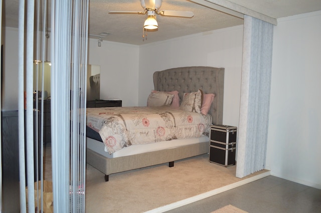 bedroom with a textured ceiling and ceiling fan