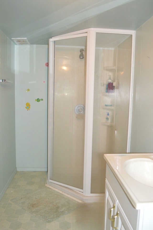 bathroom with lofted ceiling, tile patterned flooring, vanity, and an enclosed shower