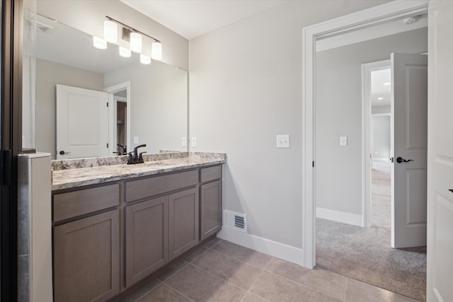 bathroom with tile patterned floors and vanity