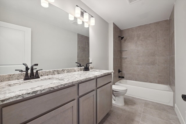 full bathroom featuring tile patterned floors, toilet, vanity, and tiled shower / bath