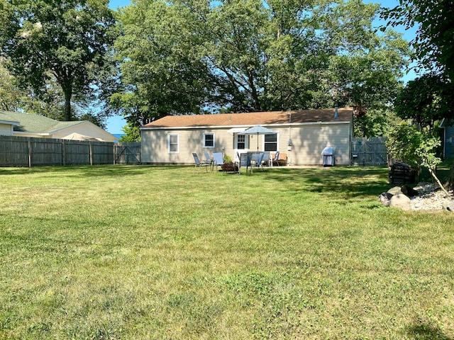 back of house with a yard and a patio area