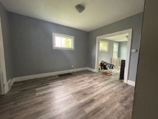 unfurnished room featuring hardwood / wood-style flooring