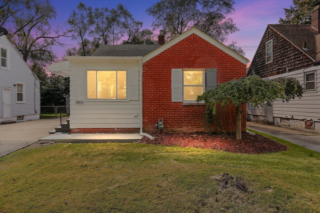 bungalow-style house with a yard